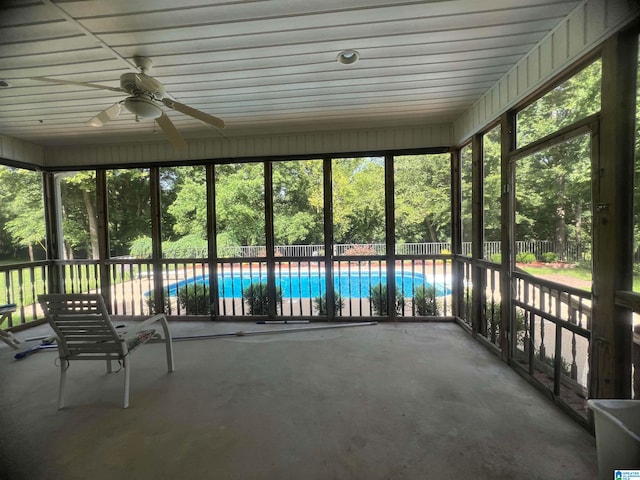 unfurnished sunroom with ceiling fan