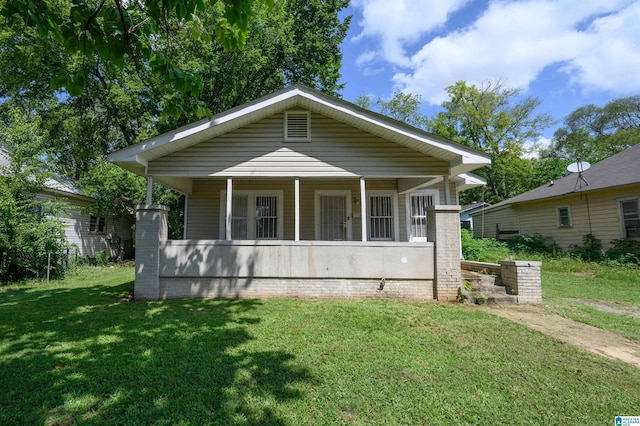 bungalow with a front yard and covered porch