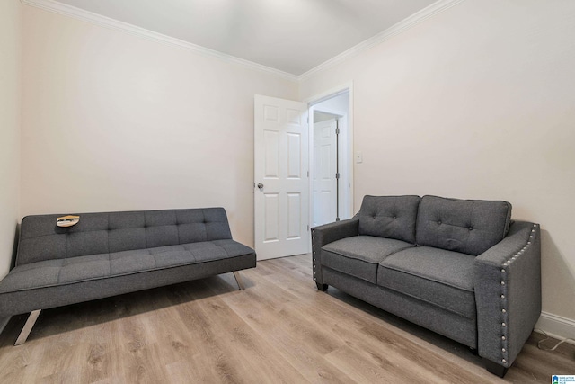 living room with light hardwood / wood-style floors and ornamental molding