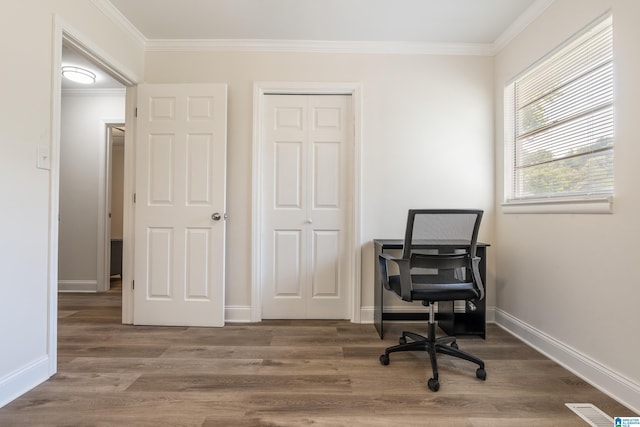 office space with ornamental molding, wood finished floors, and baseboards