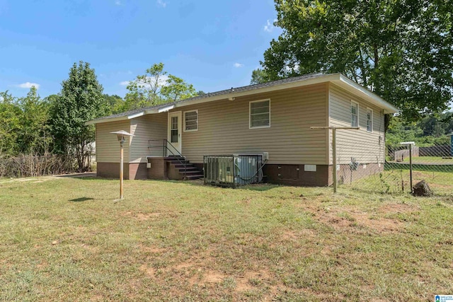 rear view of house with a yard