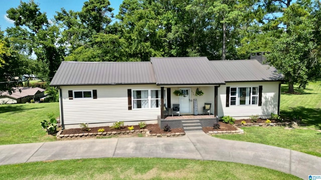 single story home with a porch and a front yard