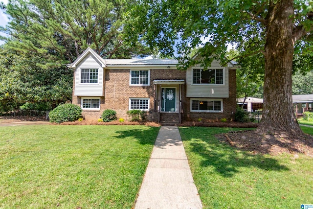 split foyer home with a front lawn