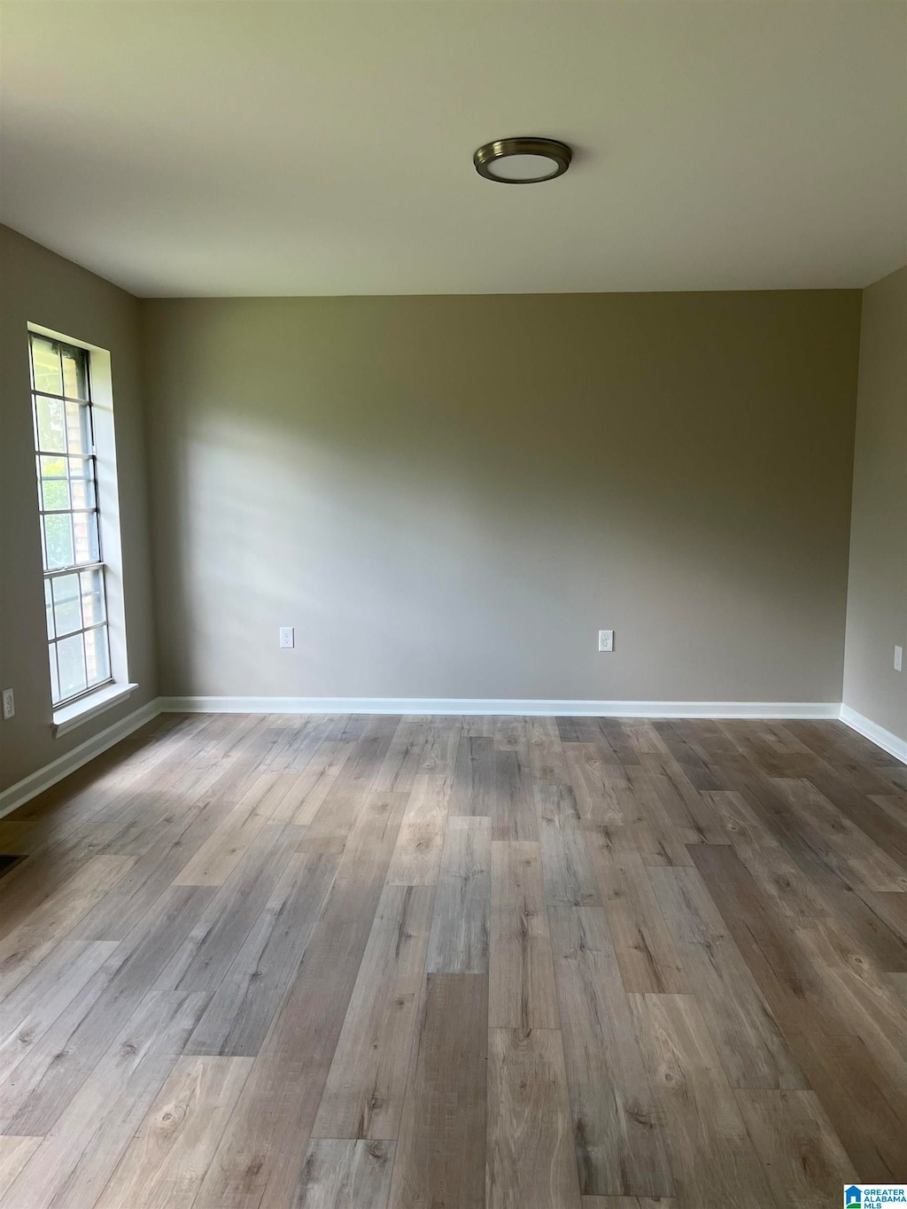 spare room with hardwood / wood-style floors