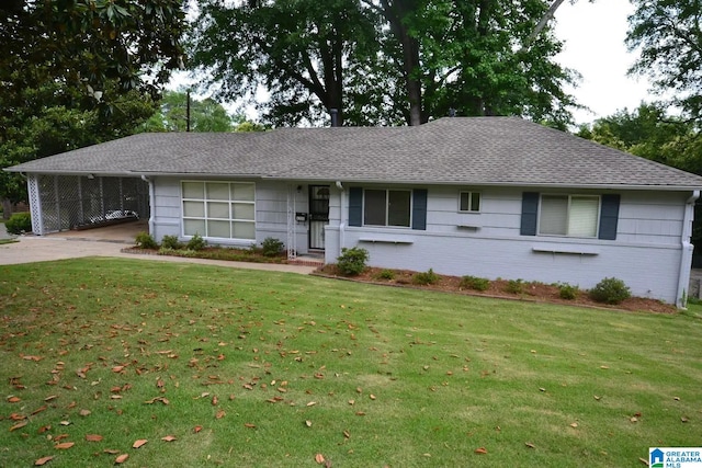 ranch-style home with a carport and a front lawn