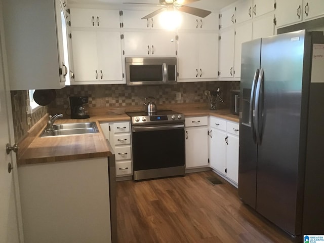 kitchen featuring stainless steel appliances, sink, and white cabinets