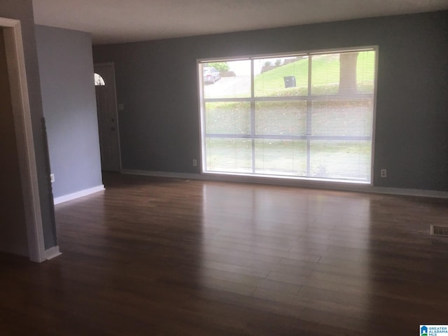 empty room with dark hardwood / wood-style floors