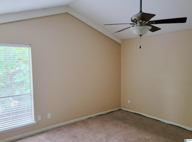 spare room with lofted ceiling, light colored carpet, and ceiling fan