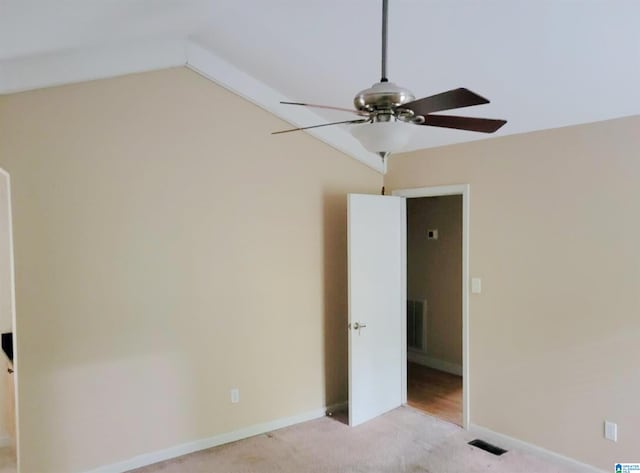 spare room with ceiling fan, carpet flooring, and lofted ceiling