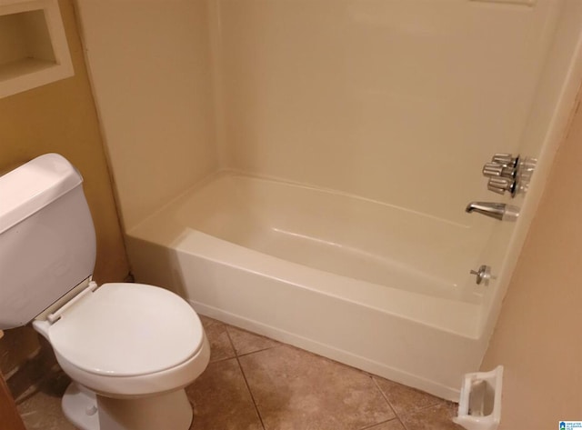 bathroom featuring toilet, tile patterned flooring, and shower / washtub combination