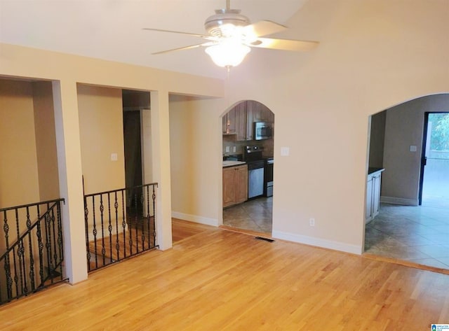 unfurnished living room featuring ceiling fan and light hardwood / wood-style flooring