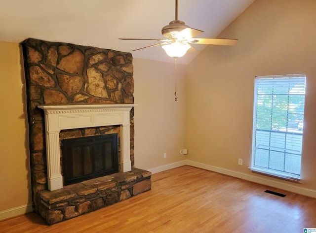 unfurnished living room with light wood-type flooring, a fireplace, and lofted ceiling