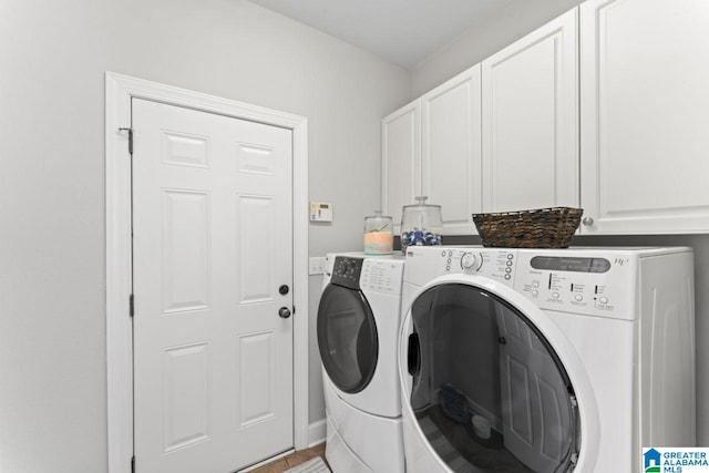 laundry area with washer and clothes dryer and cabinets