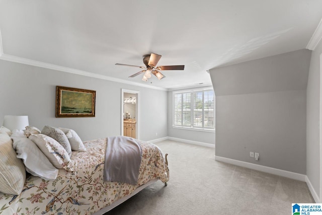 bedroom with light carpet, ornamental molding, ensuite bathroom, and ceiling fan