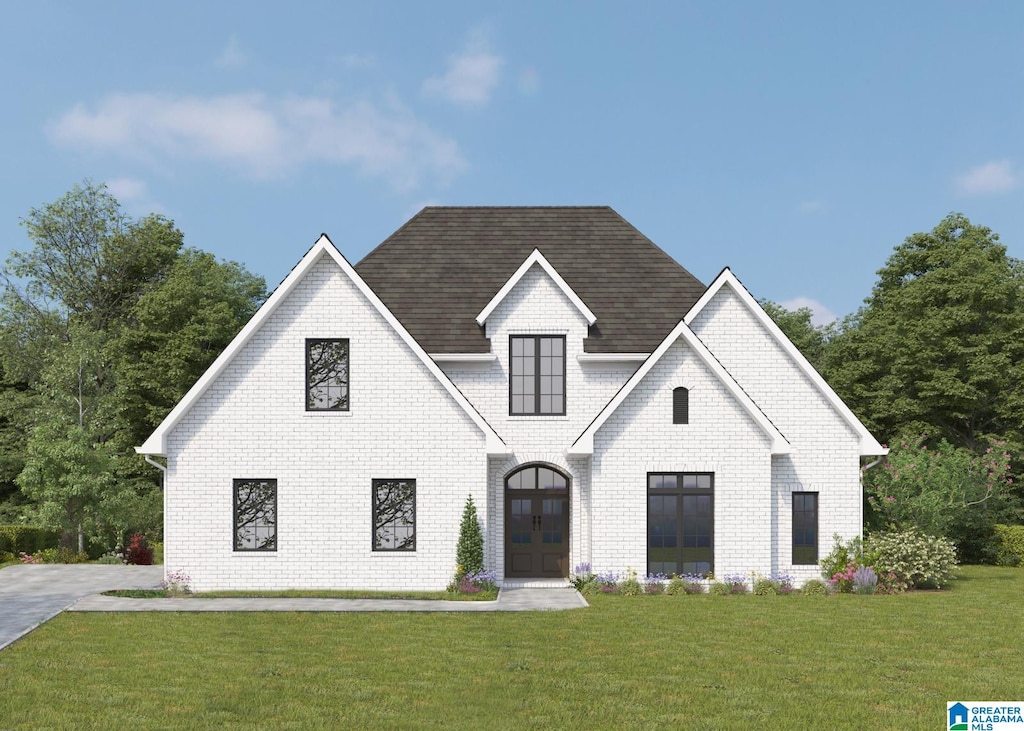 view of front facade with a front yard and french doors