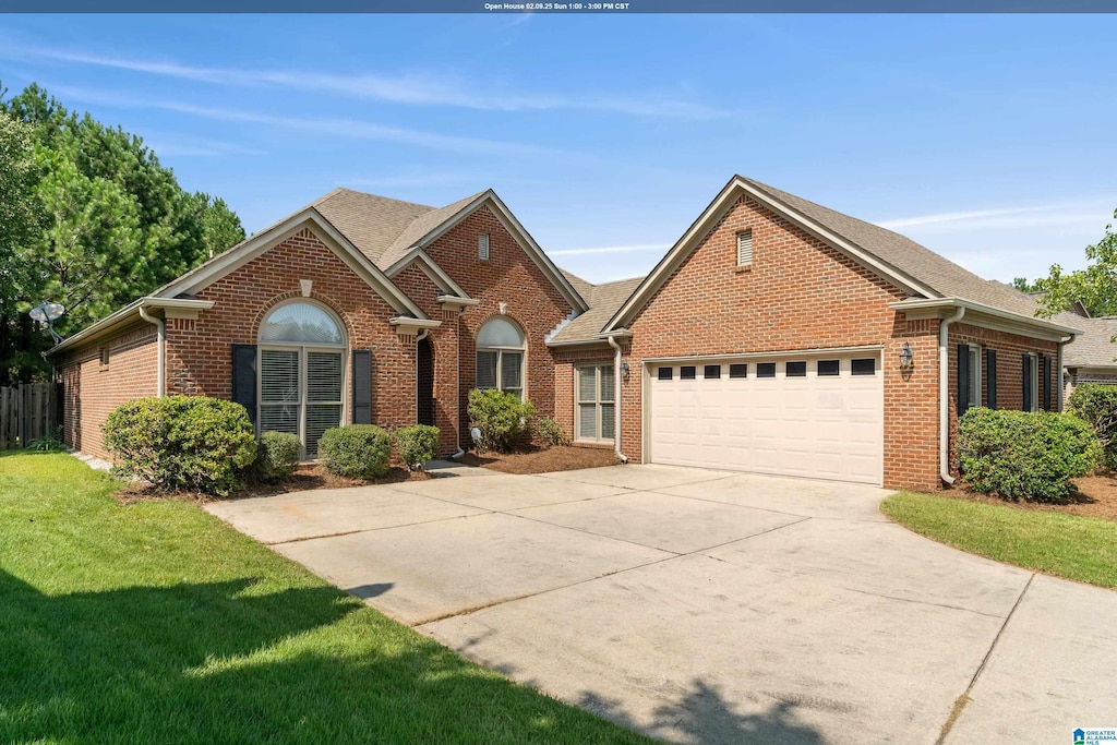 view of front of property with a garage and a front yard