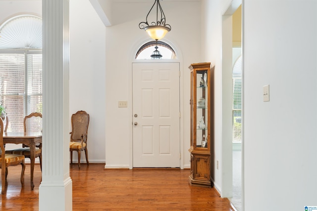 entrance foyer with hardwood / wood-style flooring and decorative columns