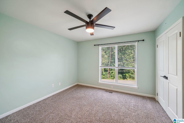 unfurnished bedroom with ceiling fan and carpet flooring