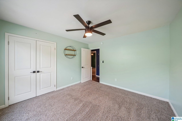 unfurnished bedroom with a closet, ceiling fan, and carpet flooring