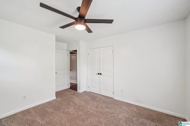 unfurnished bedroom featuring carpet floors, ceiling fan, and a closet