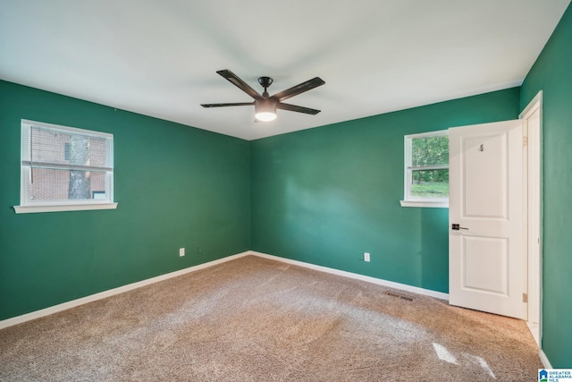 carpeted empty room featuring ceiling fan