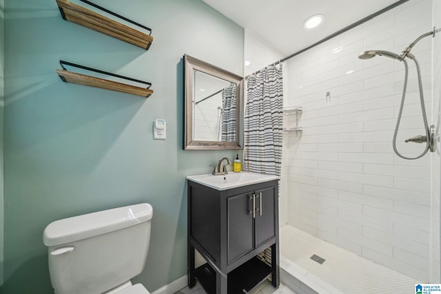 bathroom featuring toilet, vanity, and walk in shower