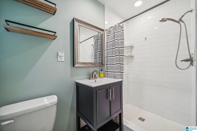 bathroom with vanity, curtained shower, and toilet