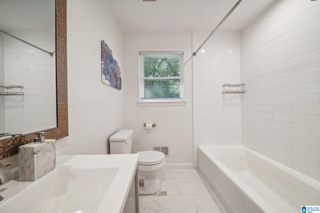 full bathroom featuring tiled shower / bath, vanity, and toilet