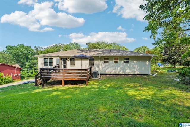 back of property featuring central AC unit, a deck, and a lawn