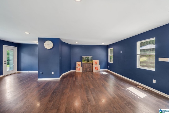 unfurnished living room featuring dark hardwood / wood-style flooring