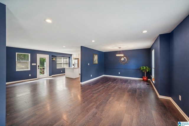 unfurnished living room with dark wood-type flooring