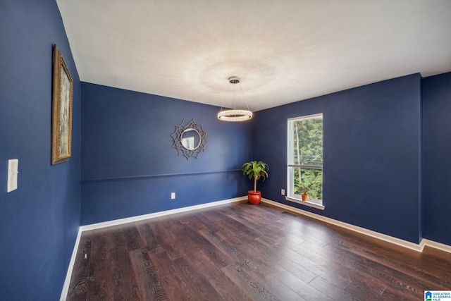 spare room with dark hardwood / wood-style flooring