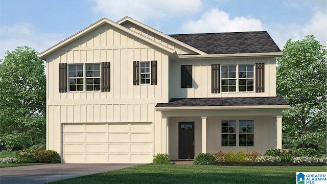 view of front of house featuring a front lawn and a garage