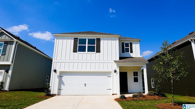 view of property featuring a garage and a front lawn