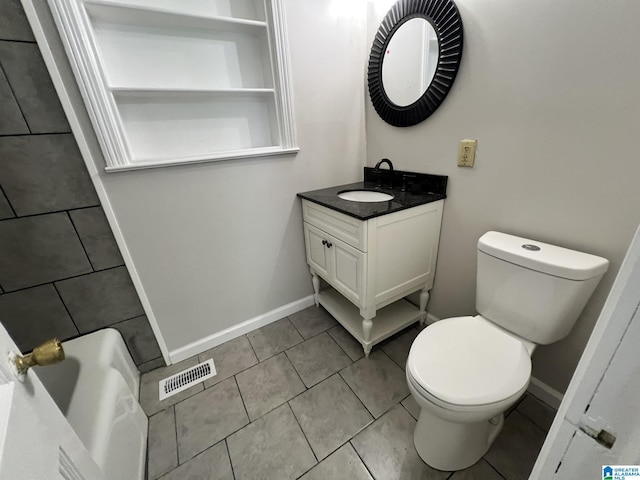 bathroom with tile patterned floors, vanity, and toilet