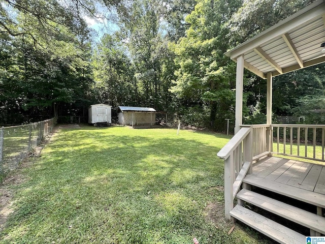 view of yard with a storage shed and a deck