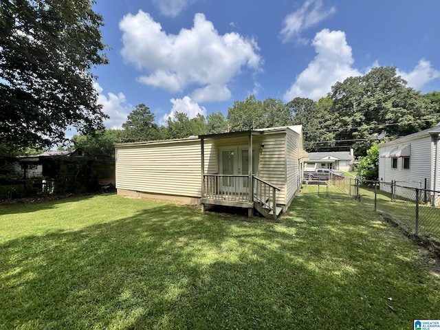 rear view of property with a yard