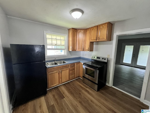 kitchen featuring black refrigerator, sink, stainless steel range with electric cooktop, dark wood-type flooring, and french doors