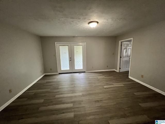 unfurnished room with dark hardwood / wood-style flooring, french doors, and a textured ceiling