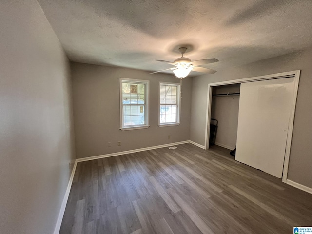 unfurnished bedroom with hardwood / wood-style floors, a closet, a textured ceiling, and ceiling fan