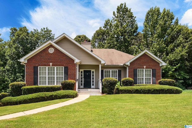 ranch-style house with a front yard, brick siding, and a chimney