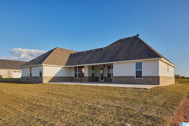 rear view of house with a patio area and a yard