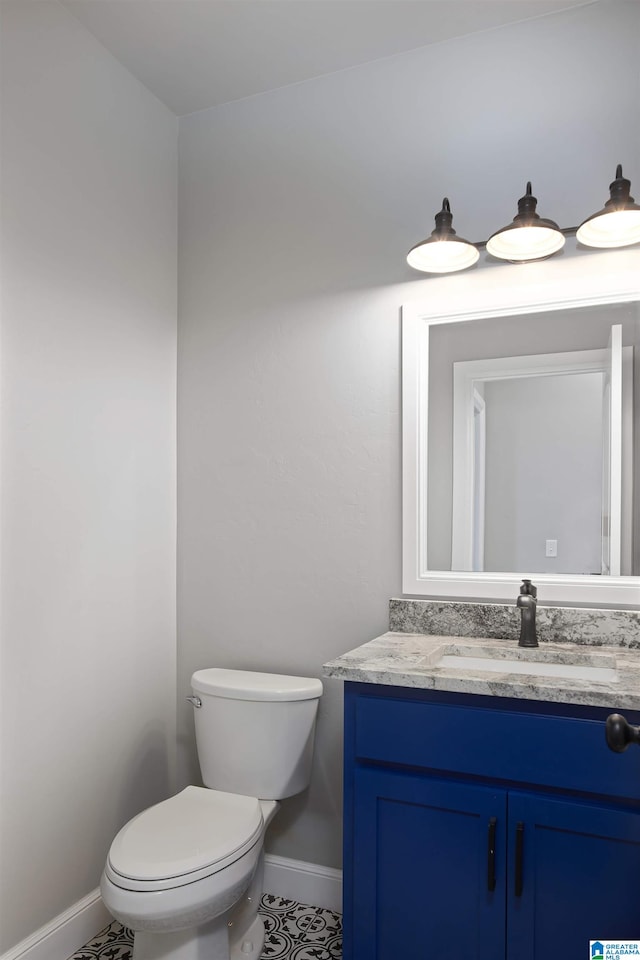 bathroom with vanity, toilet, and tile patterned flooring