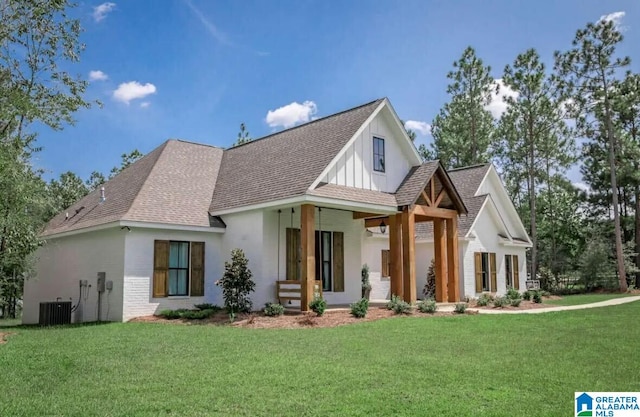 view of front of house with cooling unit and a front yard