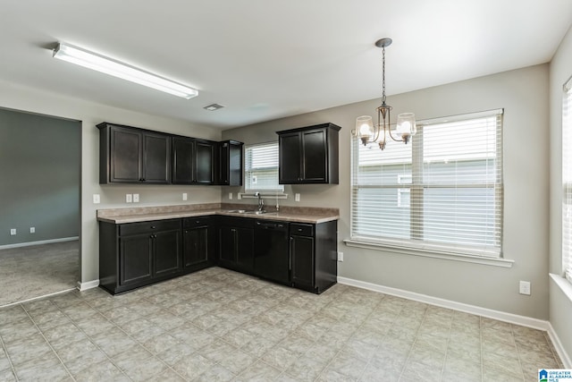 kitchen with a notable chandelier, sink, pendant lighting, and light tile patterned floors