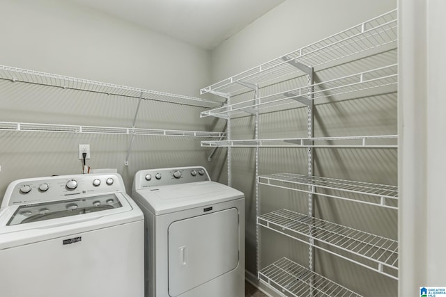 clothes washing area featuring separate washer and dryer