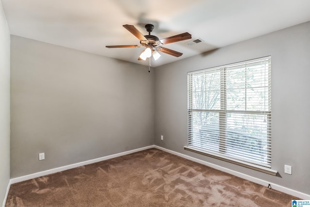 spare room with ceiling fan and carpet flooring