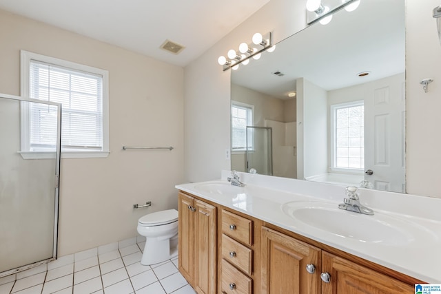 bathroom with tile patterned flooring, a tub to relax in, toilet, and double sink vanity