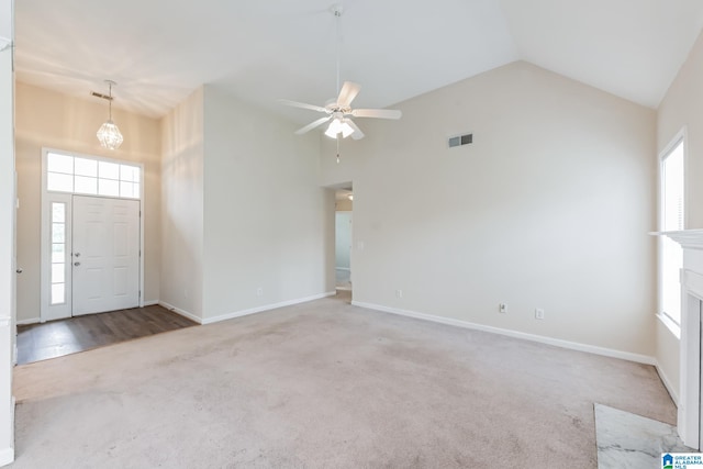 foyer entrance featuring carpet floors, high vaulted ceiling, and ceiling fan