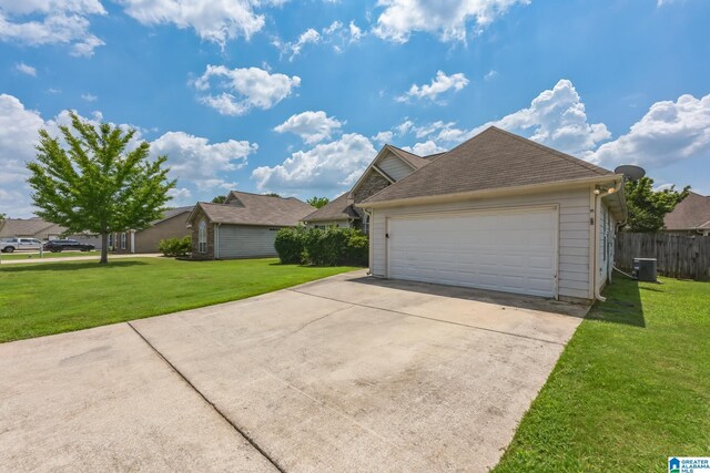 view of property exterior with central AC unit, a garage, and a yard